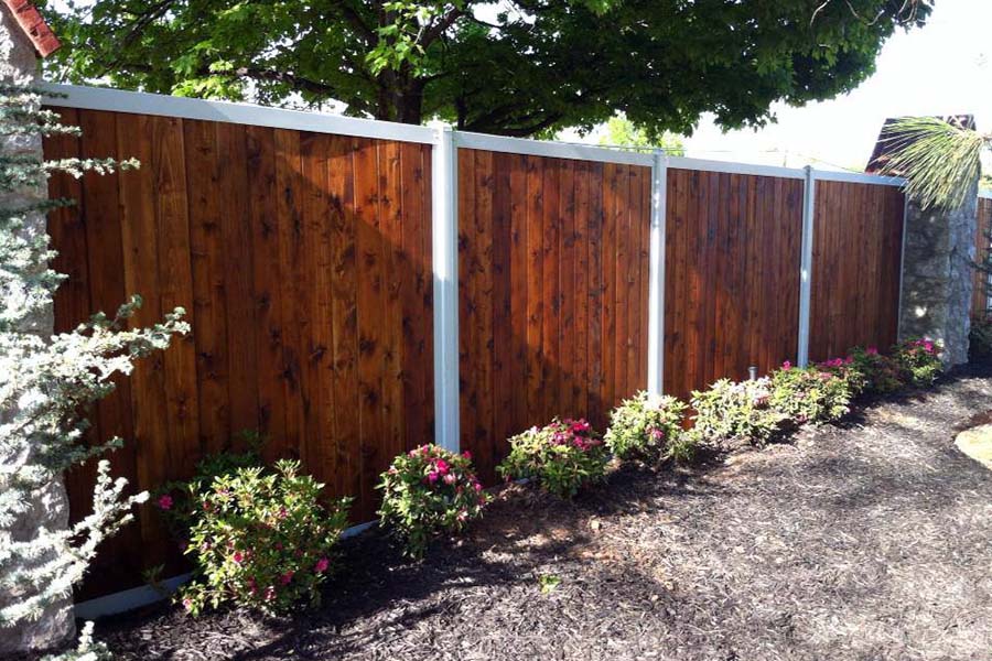 FenceTrac Stained Wood Fence With White Metal Posts