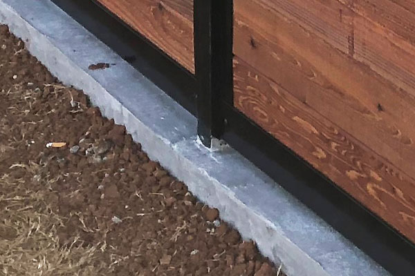 Fence Post in Poured Concrete Wall